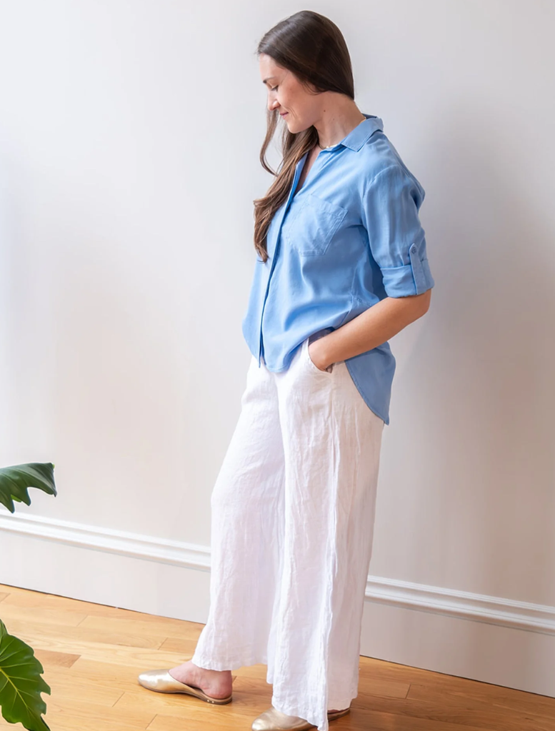 A split back button-down shirt in tidal blue, highlighting its stylish cut and fabric texture.