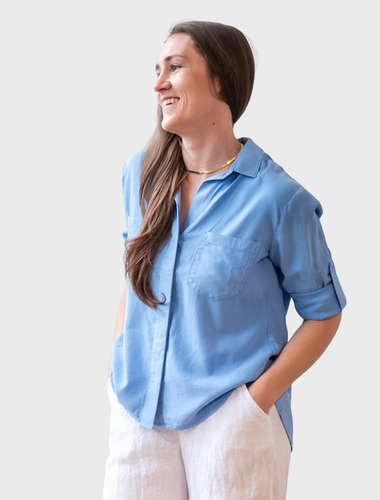 Tidal blue split back button-down shirt displayed on a hanger, showcasing its unique design and color.