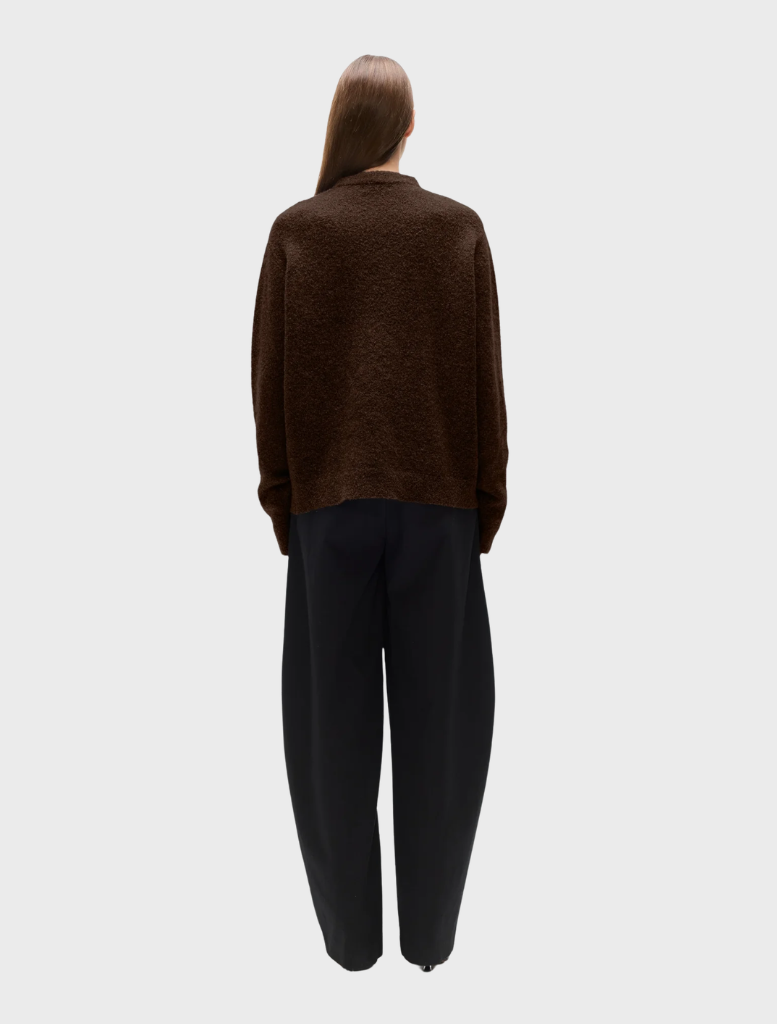 A comfortable crew neck sweater with a playful bear illustration, great for layering in chilly conditions.