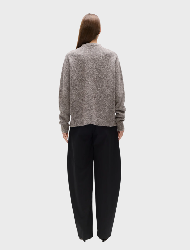 Beige grey Stella crew neck top presented on a hanger, highlighting its soft fabric and design.