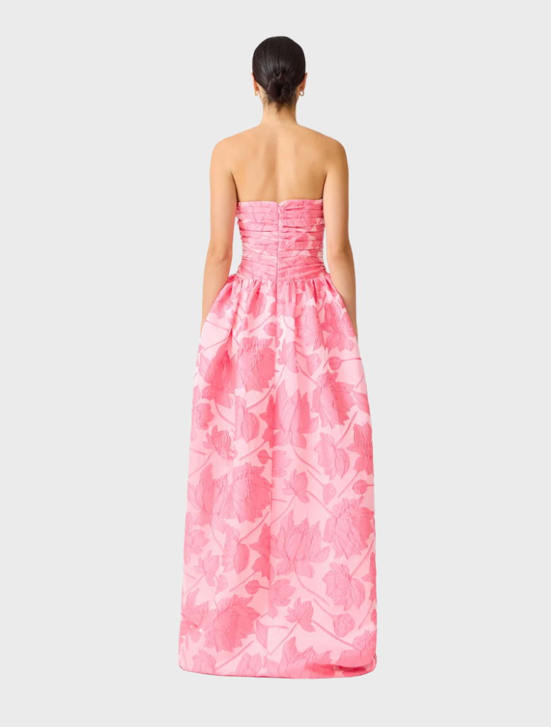 Stunning pink strapless ball gown with a sleek silhouette and dramatic skirt, designed for glamorous occasions.
