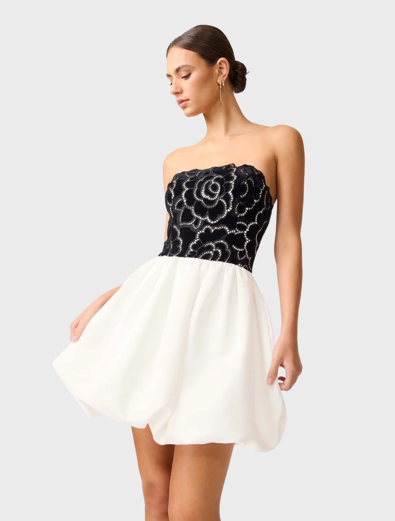 Elegant strapless mini dress in black and white, featuring a sleek fit and contemporary style for a chic look.