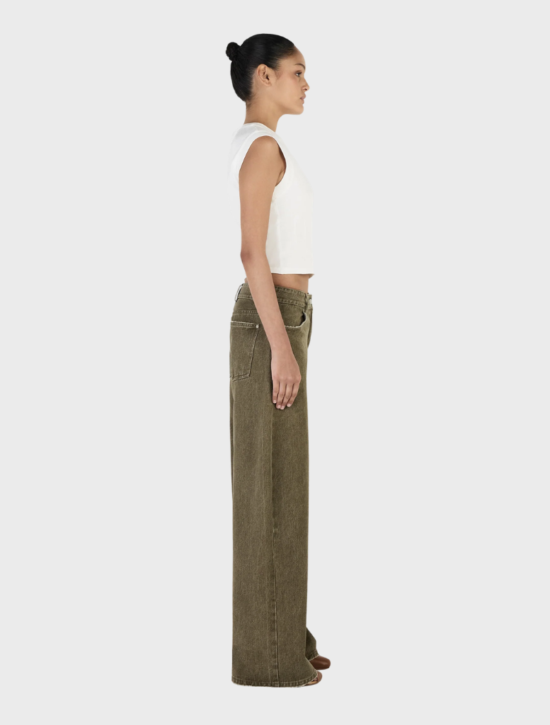 Khaki Paige Denim jeans shown on a flat surface, illustrating their tailored fit and classic denim style with detailed stitching.