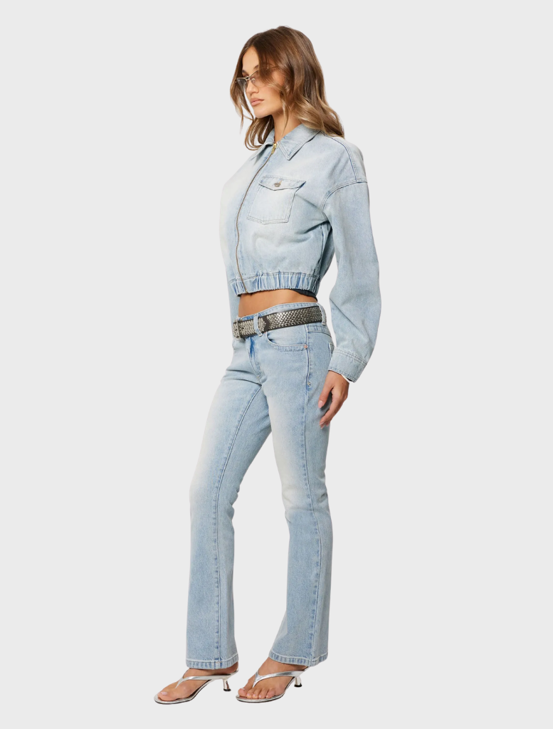 A woman wearing a crop top and jeans, highlighting the 99 Boot - Stella jean.