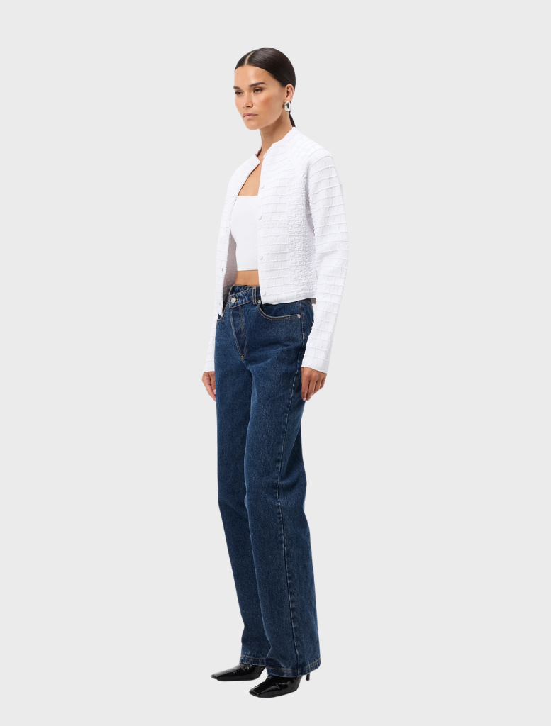 White Carter Cardigan presented on a hanger, emphasizing its classic style, long sleeves, and comfortable fabric.