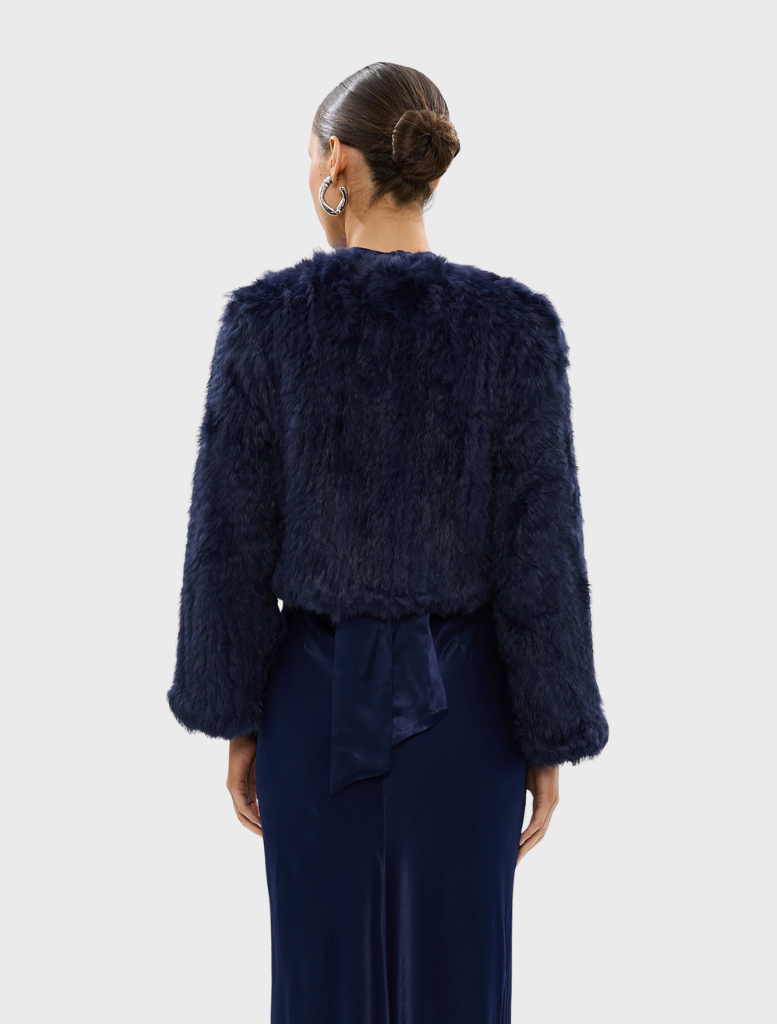 Navy Lola Crop Jacket showcasing a contemporary design, perfect for adding flair to any outfit.