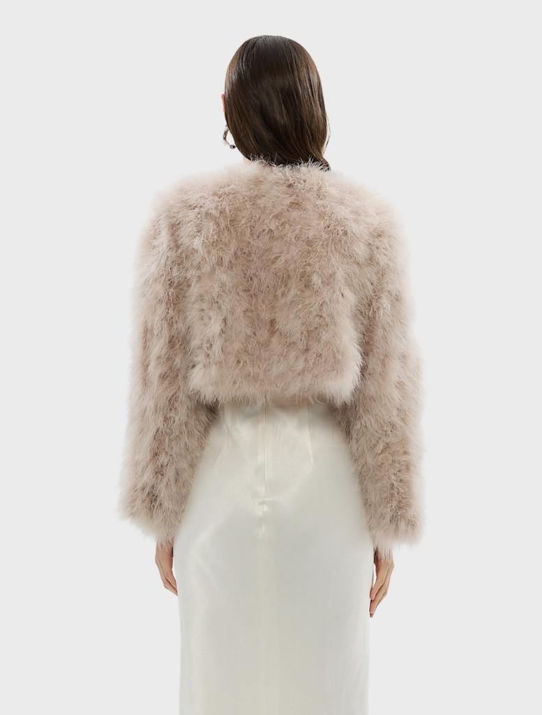 Blush Manhattan crop jacket presented, featuring a fashionable cut and soft fabric for a sophisticated appearance.