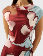 The Remy Mini Dress showcases a vibrant Marisol Bloom print, designed with a flattering fit and short sleeves for warm weather.