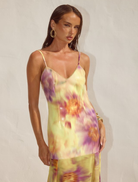 Suri Yellow Tulia Low Back Maxi Dress, showcasing a vibrant color and graceful silhouette perfect for warm weather occasions.