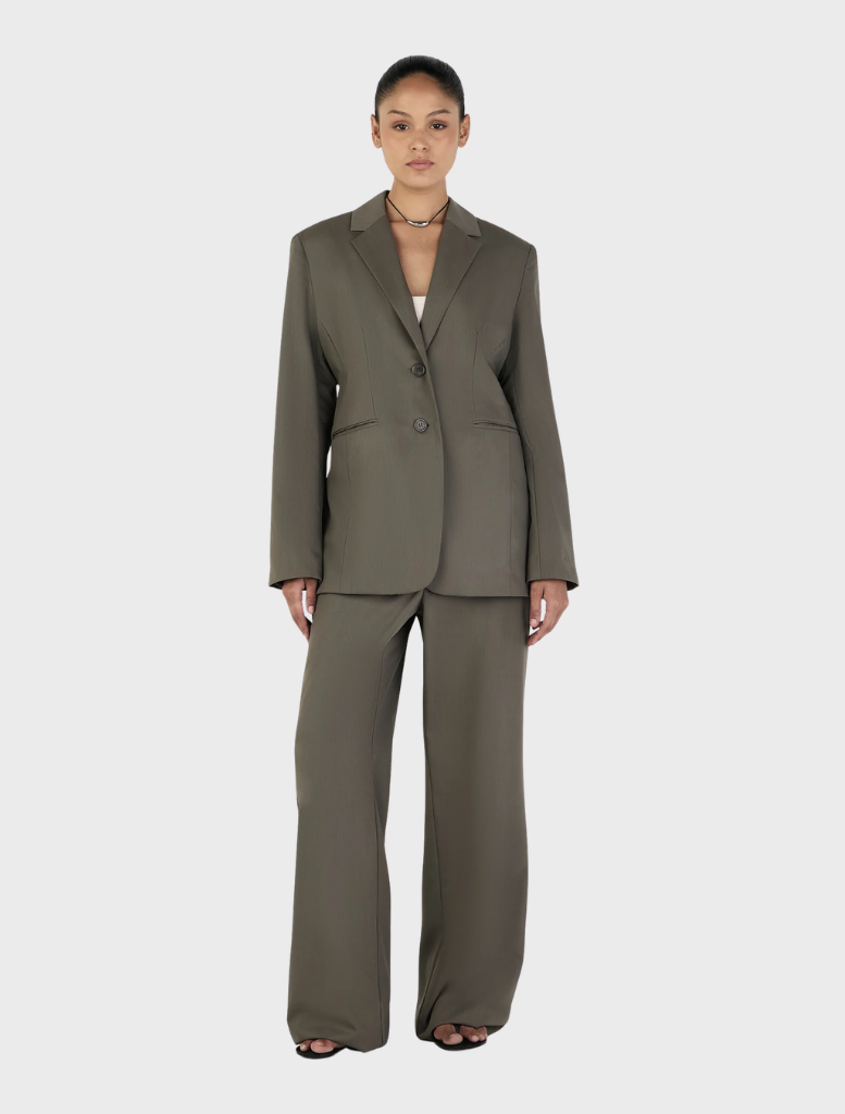 Isla Blazer in a rich forest green, emphasizing its tailored look and stylish design, presented on a hanger.