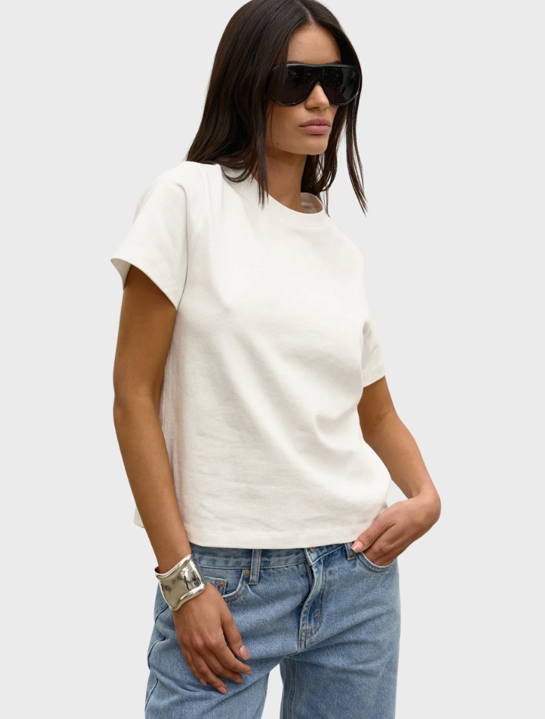 White Tess T-shirt displayed on a hanger, featuring a simple design and soft fabric suitable for casual wear.