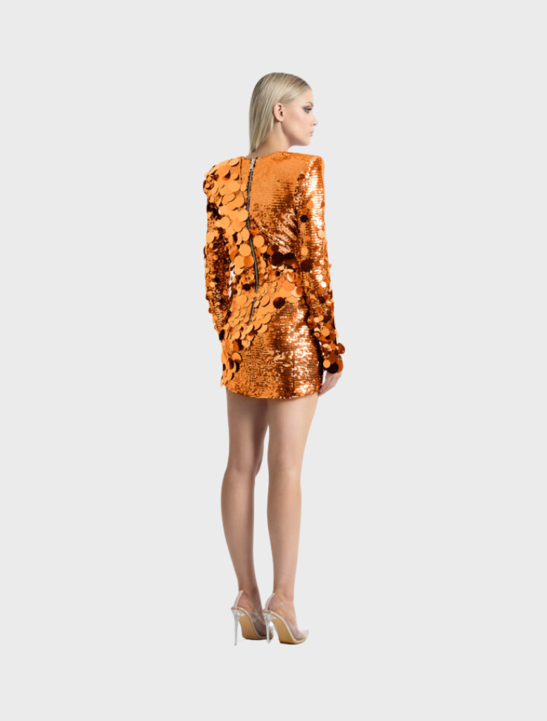 Vibrant orange mini dress with a shimmering prism effect, designed to enhance the figure and add a playful touch.