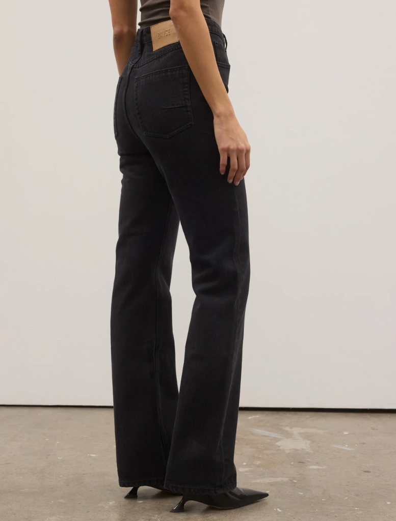 Backstage image of Tilly Bootleg Jean, illustrating its fashionable bootleg style amidst the hustle of a fashion event.