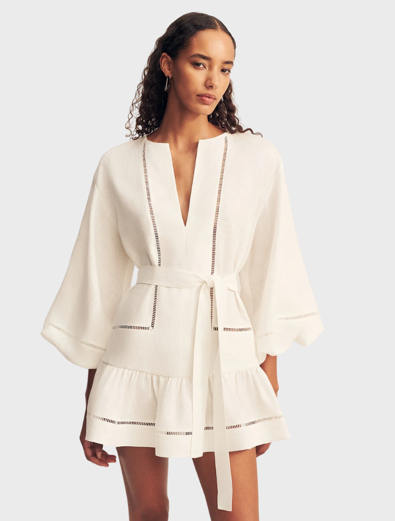 Elegant ivory mini dress showcasing balloon sleeves and a flattering silhouette, perfect for stylish summer outings.