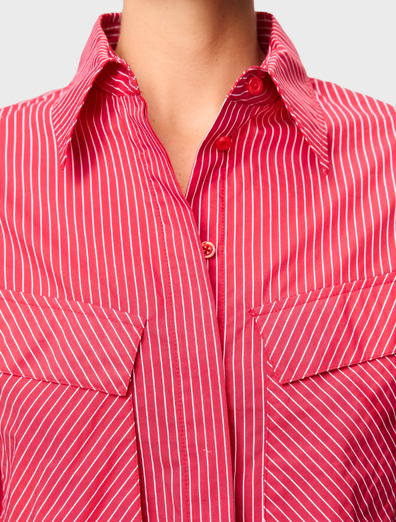 Close-up of a red striped Tudor shirt, emphasizing the fabric texture and bold stripe design.