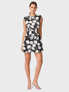 Chic black and white Carol Tulip mini dress showcasing a floral print and a flared design, suitable for various events.