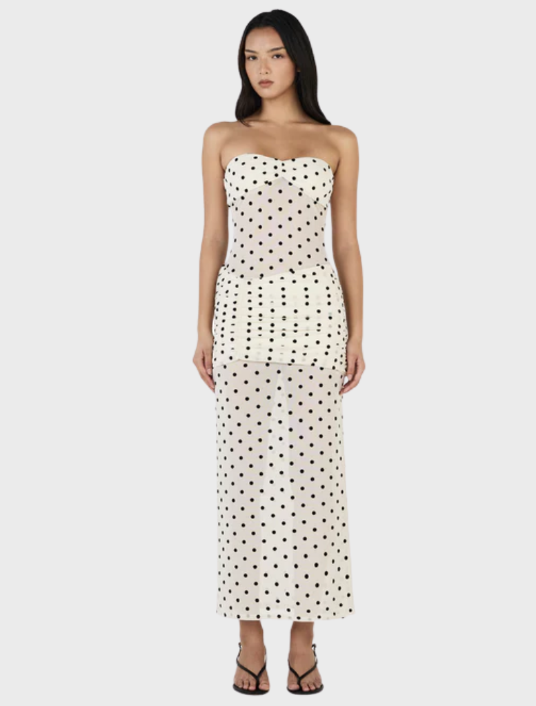 Cream-colored maxi dress with a playful polka dot design, perfect for summer outings or special occasions.