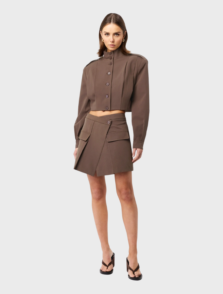 A mocha Vault Bomber jacket presented on a hanger, emphasizing its contemporary look and texture.