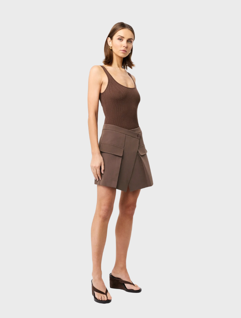 Mocha Vault Mini Skirt presented on a plain backdrop, illustrating its chic design and suitability for different styles.