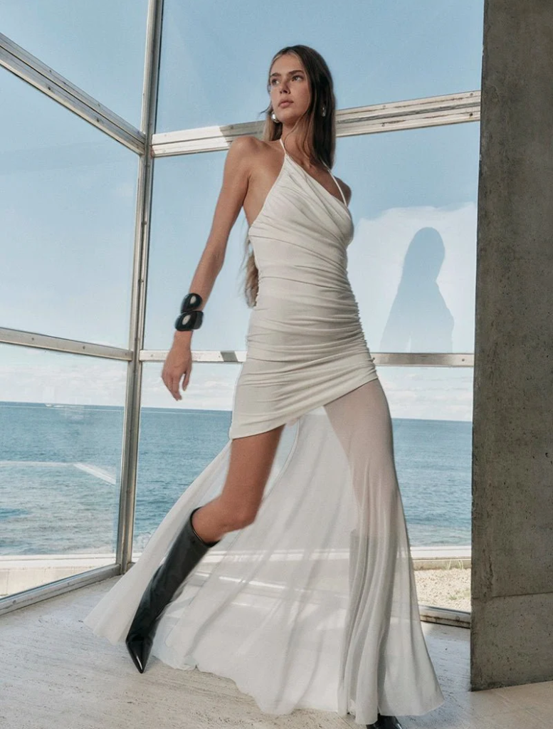 White Violetta ruched maxi dress, designed with a fitted top and a long, flowing skirt for a sophisticated look.