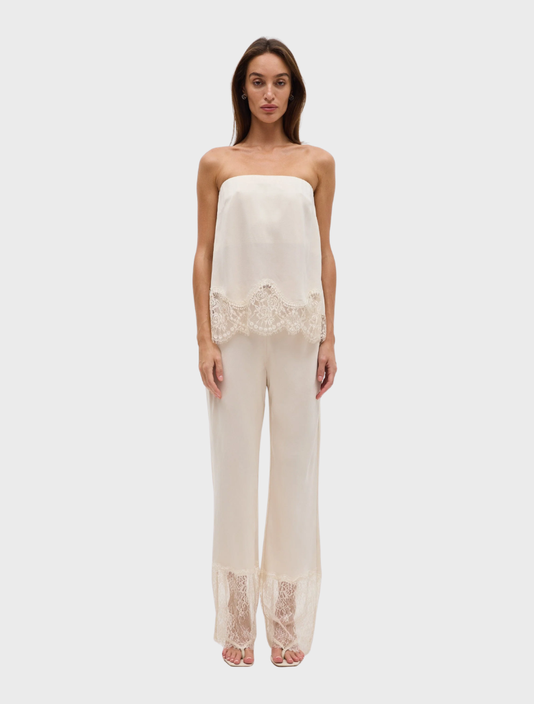 Visions Lace Pant in buttercream features a slim fit, scalloped waistband, and sheer lace panel hem for a delicate look.