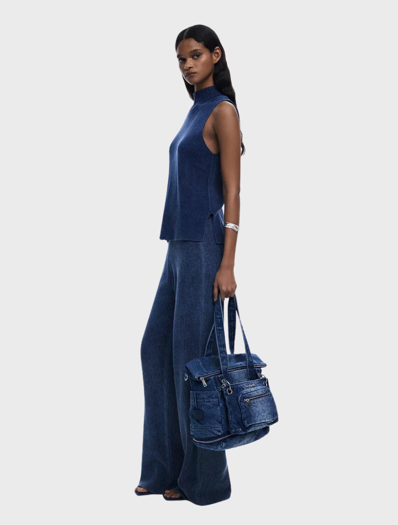 Denim Voyager Mini Backpack in blue featuring a secure zipper closure for convenient storage and transport.