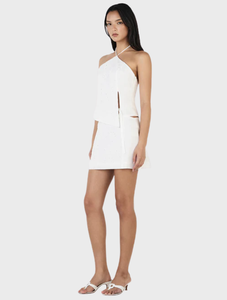 Chic Celina Mini Skirt in white Anglaise, featuring beautiful lace details for a stylish and elegant outfit.