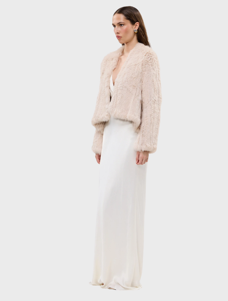 Stylish Emma Jacket in stone, featuring an open front and a unique design with a shorter front and longer back, made of rabbit fur.