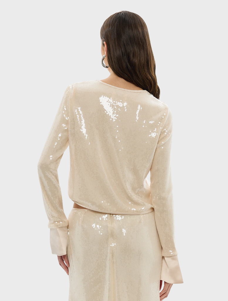 Pearl pink sequin top by Nadine, featuring a shimmering finish and a stylish design suitable for various occasions.