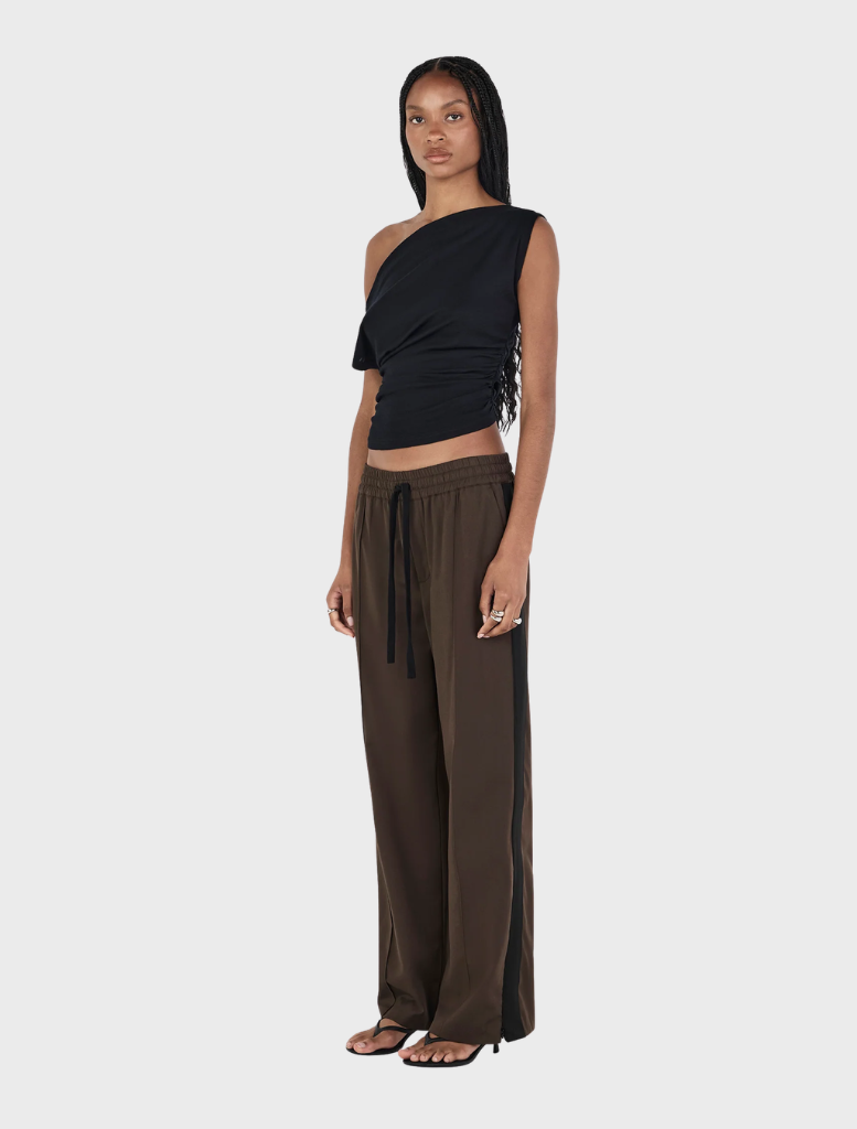 Black Pip wool top displayed on a hanger, showcasing its soft texture and simple design.