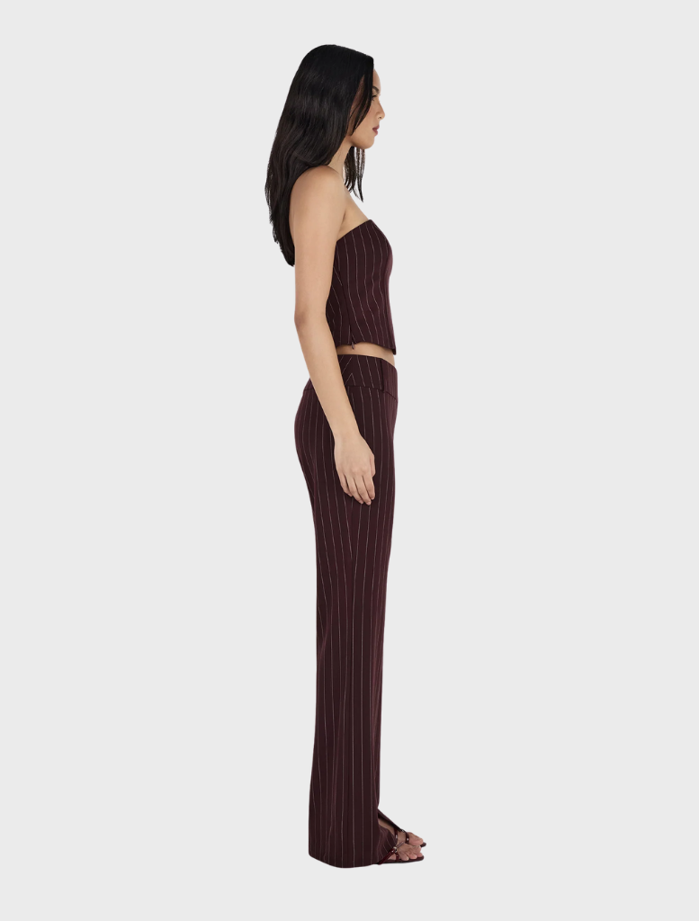 A model is dressed in a burgundy striped top and wide-leg pants, representing the Yolanda Suit Pant in Cherry Choc Stripe.