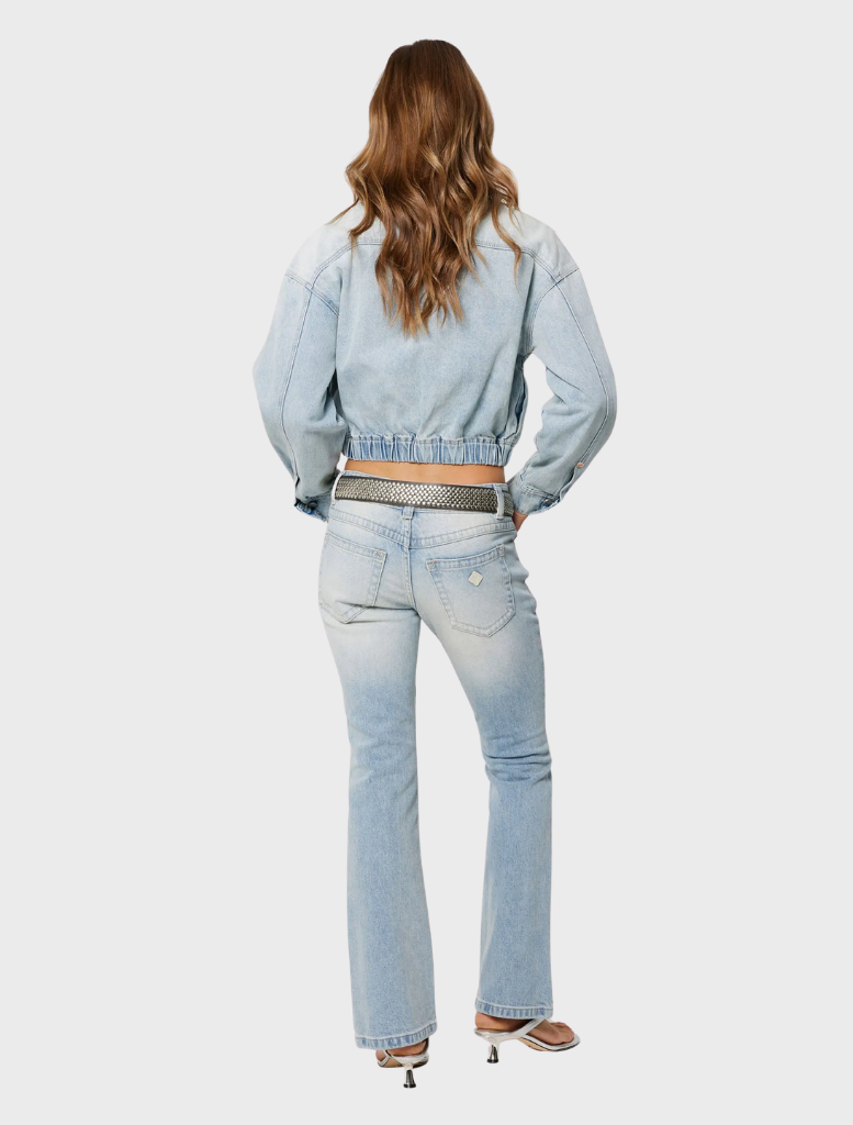 A woman in a crop top and jeans, presenting the 99 Boot jeans - Stella fashion look.