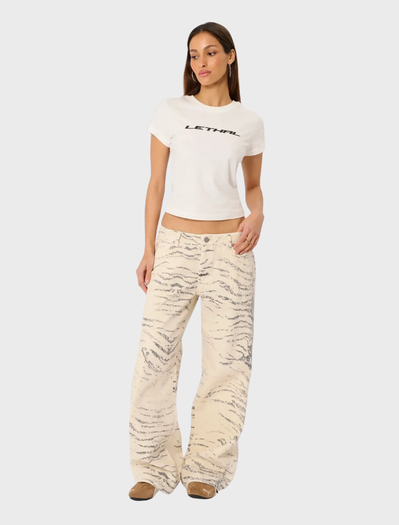 A stylish model wearing a pair of baggy jeans, showcasing the Valentina Rcy design in a trendy urban setting.