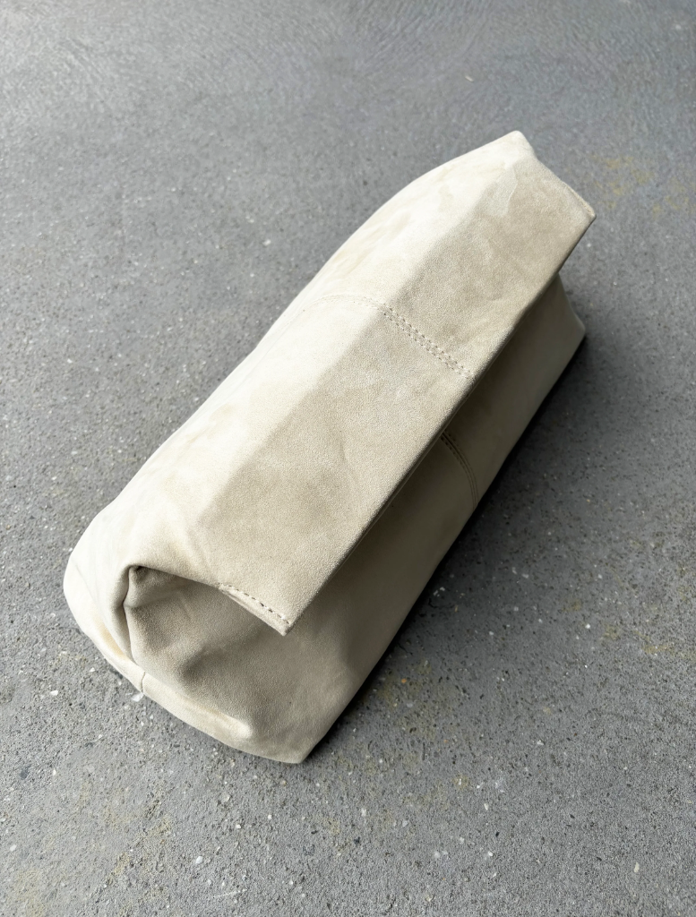 Beige leather pouch on a gray surface