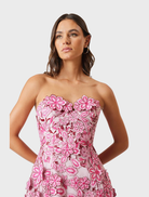 Roseate Floral Mini Dress features a strapless design in a pink floral pattern.
