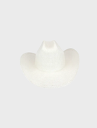 A white Addison Cowboy hat laid on a natural wood surface, illustrating its classic cowboy style and refined details.