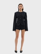 Black Alba Jacket laid flat, emphasizing its material and tailored fit.