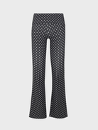 Elegant black pants adorned with small white dots, perfect for versatile styling in various settings.