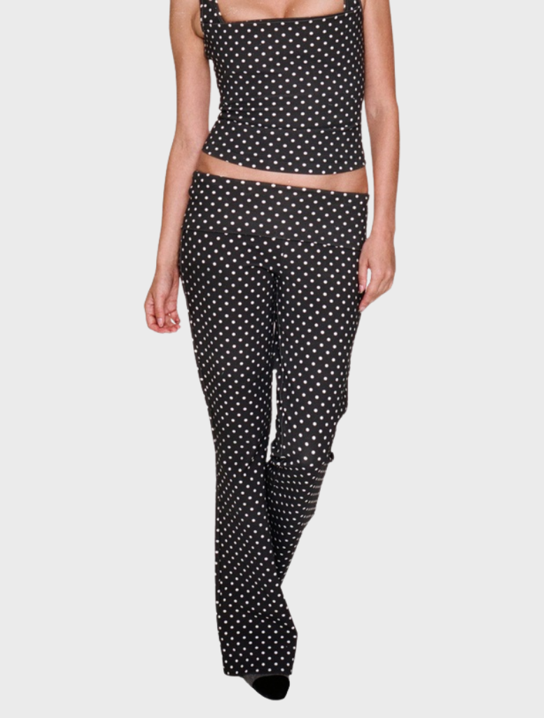 Black pants with small white dots, featuring a sleek design suitable for casual or formal occasions.