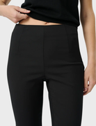 Chic black Alfie Capri pants feature a playful scalloped hem and comfortable elastic waistband, perfect for stylish everyday outfits.