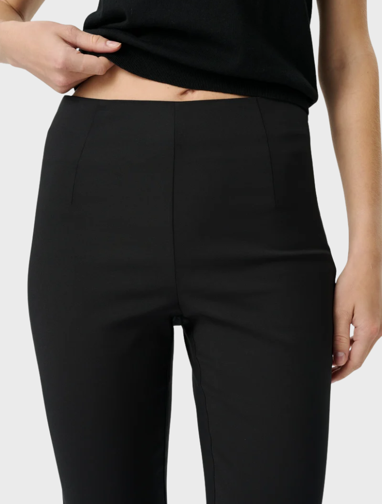 Chic black Alfie Capri pants feature a playful scalloped hem and comfortable elastic waistband, perfect for stylish everyday outfits.
