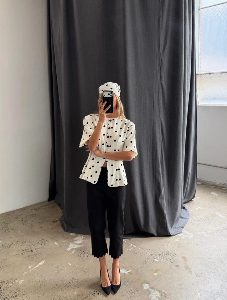 Black Alfie Capri pants feature a scalloped hem, elastic waistband, and a modern, retro-inspired silhouette for stylish comfort.