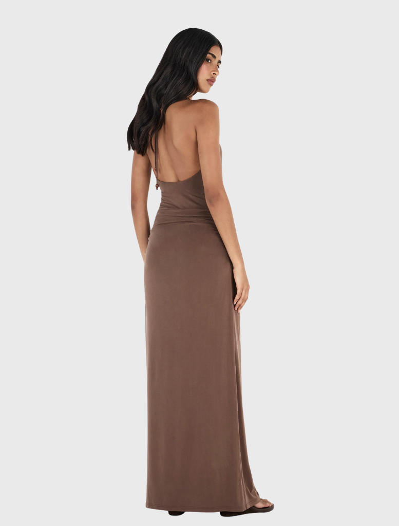 Fitted chocolate halterneck maxi dress with draped skirt, gathered hips, and adjustable beaded tie closure.