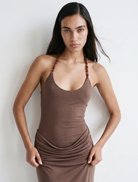 Chocolate maxi dress featuring a fitted bodysuit, draped skirt, and adjustable halter tie for an elegant silhouette.