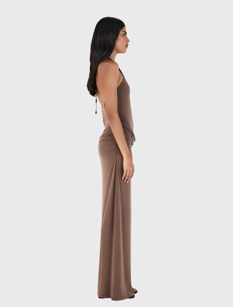 Fitted chocolate maxi dress with a halterneck, draped skirt, and gathered seams, made from sustainable materials.