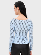 Amelia Top in blue, decorated with small dots, offering a chic and trendy look for casual wear.