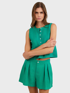 Stylish aqua green shorts with double pleats, perfect for summer wear, presented against a neutral backdrop.