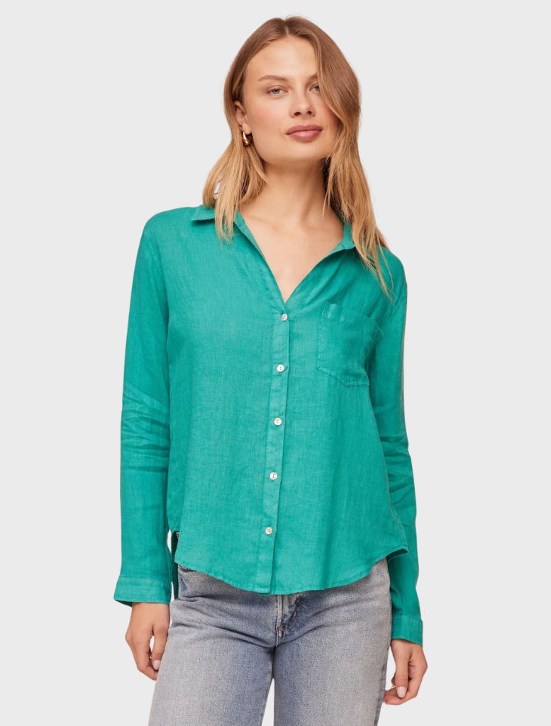 Close-up of an aqua green button-down shirt with a pocket, highlighting its fabric texture and color.