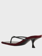 Elegant black sandals with red fur detailing, named Arli - Burgundy Pony.
