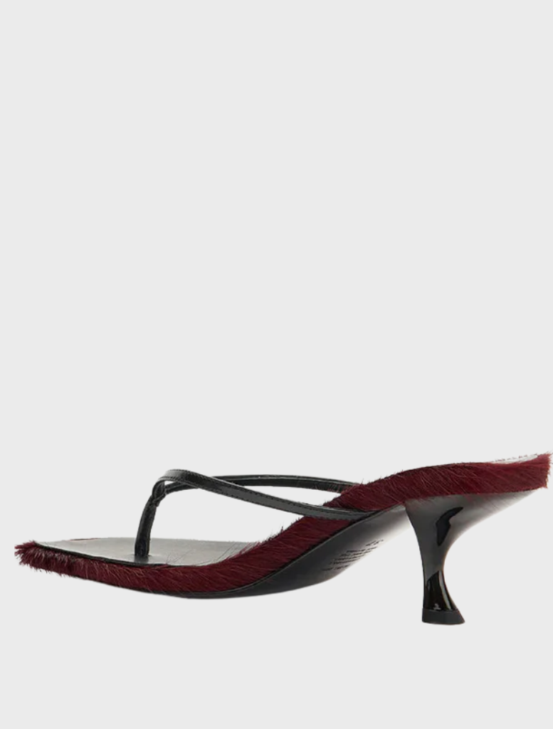 Elegant black sandals with red fur detailing, named Arli - Burgundy Pony.